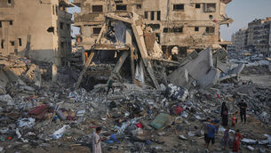 Palestinians salvage their belongings from the rubble of a building and tents destroyed in an Israeli airstrike in Gaza City (Jehad Alshrafi/AP) Palestinians salvage their belongings from the rubble of a building and tents destroyed in an Israeli airstrike in Gaza City (Jehad Alshrafi/AP)