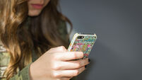 EMKE04 Girl using mobile phone