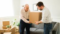Moving home iStock-1428205127.jpg Elderly man moving into a new apartment with the help of his son