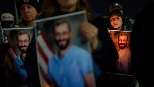 People hold up photos during a vigil for Alex Pretti, who was shot and killed by federal immigration enforcement in Minneapolis (John Locher/AP) People hold up photos during a vigil for Alex Pretti, who was shot and killed by federal immigration enforcement in Minneapolis (John Locher/AP)