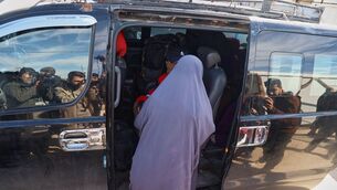 Family members of suspected IS militants who are Australian nationals board a van heading to the airport in Damascus during the first repatriation operation of the year, in eastern Syria (Baderkhan Ahmad/AP) Family members of suspected IS militants who are Australian nationals board a van heading to the airport in Damascus during the first repatriation operation of the year, in eastern Syria (Baderkhan Ahmad/AP)