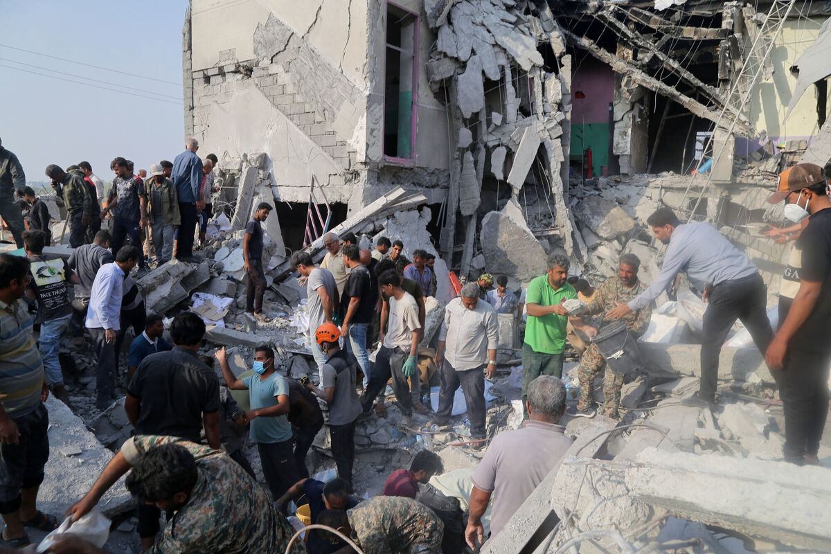 Rescue workers and residents searching the rubble after the airstrike on a girls' school in Minab, Iran, on Saturday, February, 28. The Handala hacktivist group said its 'wiper' cyberattack on Stryker was in retaliation for that attack. Picture: Abbas Zakeri/Mehr/AP 