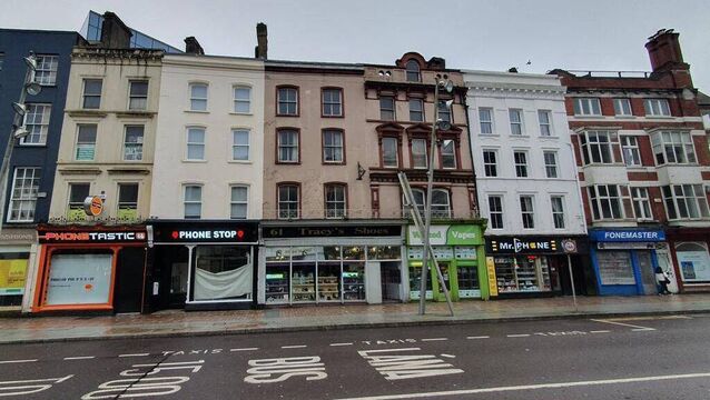 <p>A range of phone and vape shops on Patrick St. Picture: Frank O’Connor/DerelictIreland </p>