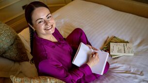 <p>Irish Examiner reporter Breda Graham journals as part of a wind-down routine while testing sleep aids in the Shandon Suite at Hayfield Manor. Picture: Chani Anderson</p>
