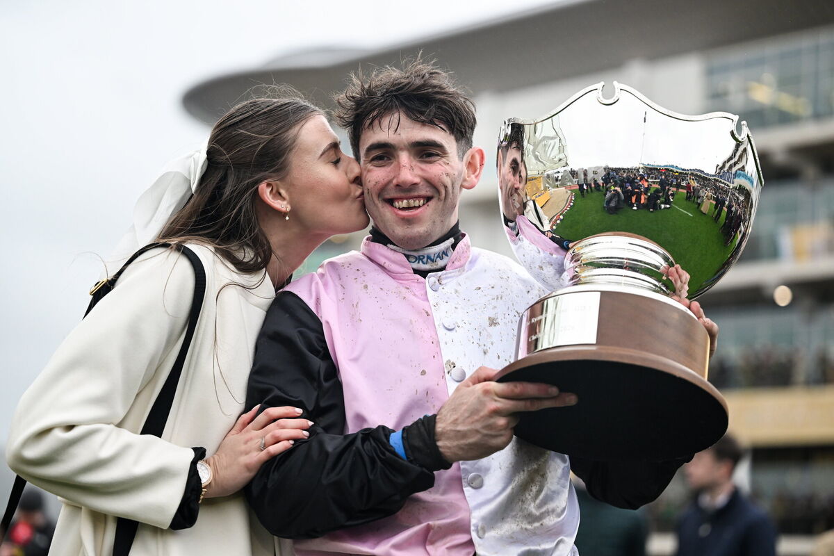 Jockey Darragh O'Keeffe celebrates with girlfriend Grace Cooke and the trophy after winning the Ryanair Chase with Heart Wood. Pic: David Fitzgerald/Sportsfile