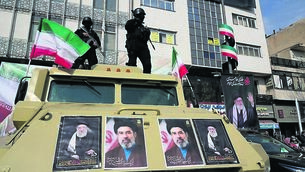 <p class="contextmenu internal_Caption">Policemen stand on top of their car with pictures of the late Iranian supreme leader Ayatollah Ali Khamenei and his son and successor Ayatollah Mojtaba Khamenei during a rally of support in Tehran, Iran. <span class="contextmenu emphasis CaptionCredit"> 	Picture: Vahid Salemi/AP</span>
            </p>