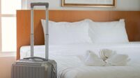 Suitcase or luggage bag near by bed in a modern hotel room. Inter views of modern hotel room