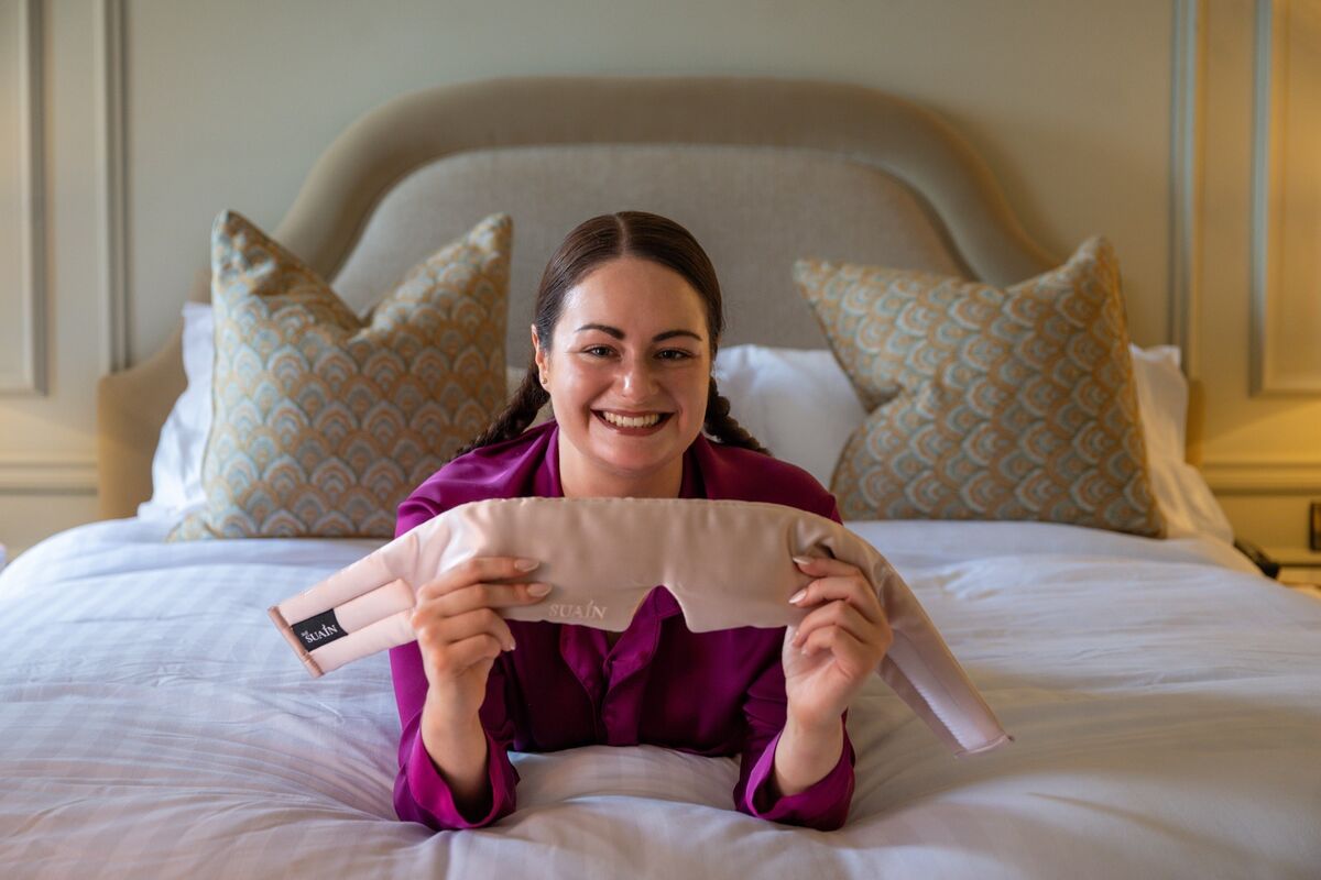 Irish Examiner reporter Breda Graham tries out a Suain silk deep sleep mask while testing various sleep aids in the Shandon Suite at Hayfield Manor. Picture Chani Anderson