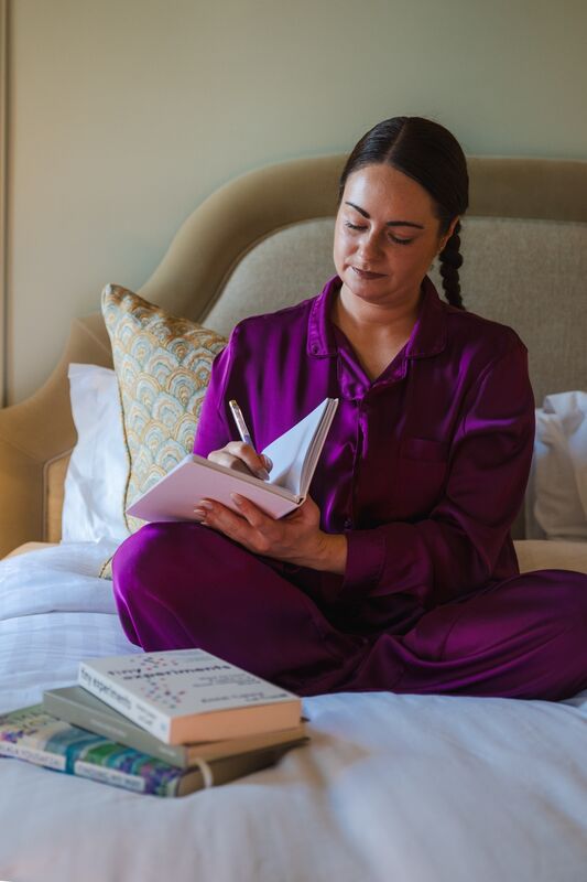 Irish Examiner reporter Breda Graham journals as part of a wind-down routine while testing sleep aids in the Shandon Suite at Hayfield Manor. Picture Chani Anderson Irish Examiner reporter Breda Graham journals as part of a wind-down routine while testing sleep aids in the Shandon Suite at Hayfield Manor. Picture Chani Anderson