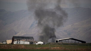 <p>Smoke rises to the sky at an air base following attacks early morning, in Harir, Iraq, Thursday, March 12, 2026. (AP Photo/Leo Correa)</p>