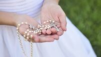 Rosary in Girl's hands