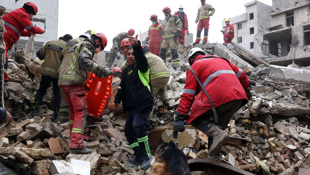 <p>Rescue workers search for survivors in the rubble after a strike in southern Tehran on Friday. Picture: AP Photo/Sajjad Safari</p>