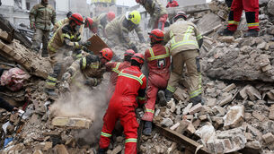 <p>Rescue workers search for survivors in the rubble after a strike in southern Tehran, Iran, Friday, March 13, 2026. (AP Photo/Sajjad Safari)</p>