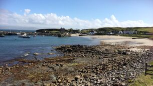 <p>Clare Island Harbour, with Clare Island Castle, the 16th century Grace O’Malley stronghold, visible in the background above the harbour walls.</p>