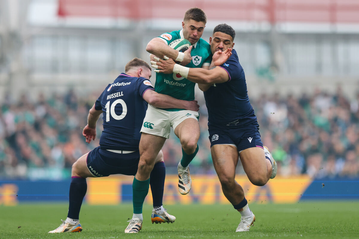 DOUBLE TEAM: Ireland's Jack Crowley is tackled by Scotland's Sione Tuipulotu and Finn Russell.