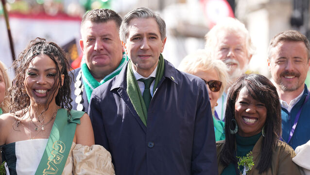 <p>Tanaiste Simon Harris (centre) during the St Patrick's Day parade in central London. Picture: Lucy North/PA</p>