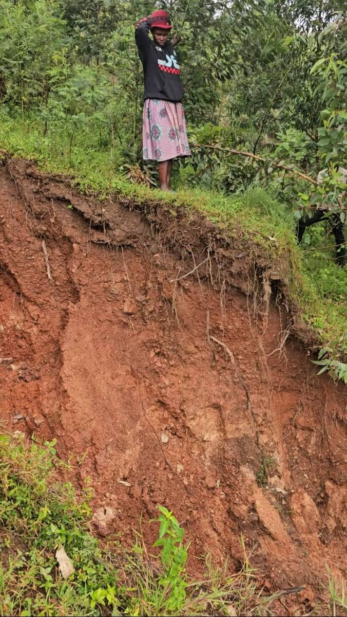 Uwamahoro looks where her farmland was destroyed in a landslide in Rwanda