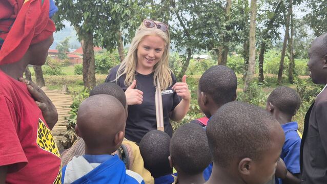 <p>Claire Kelly of Trocaire talking with school children in Rwanda</p>
