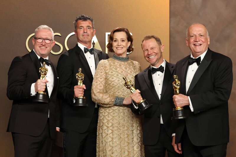 Richard Baneham, second from right, holds his Best Visual Effects Oscar alongside Sigourney Weaver, and fellow members of the team from Avatar: Fire and Ash, Daniel Barrett, Eric Saindon, and Joe Letteri. (Photo by Frazer Harrison/Getty Images) Richard Baneham, second from right, holds his Best Visual Effects Oscar alongside Sigourney Weaver, and fellow members of the team from Avatar: Fire and Ash, Daniel Barrett, Eric Saindon, and Joe Letteri. (Photo by Frazer Harrison/Getty Images)