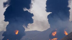 <p>Plumes of smoke and fire rise after debris from an intercepted Iranian drone struck an oil facility, according to authorities, in Fujairah, United Arab Emirates. Picture@ AP Photo/Altaf Qadri.</p>