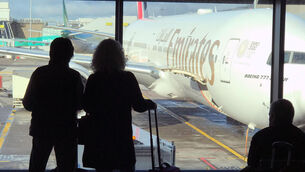 <p>Passengers looking out the window at Emirates planes parked at Dublin Airport. Picture: RollingNews.ie</p>
