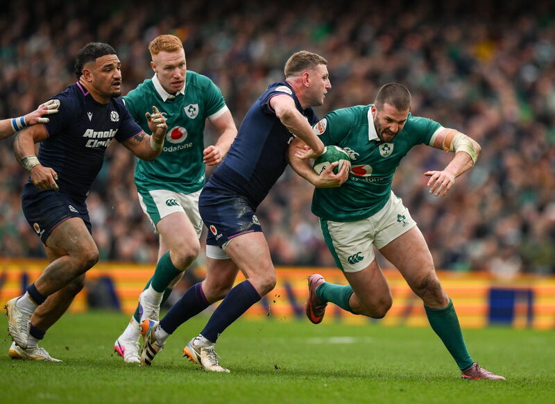 Stuart McCloskey is tackled by Finn Russell. Pic: Brendan Moran/Sportsfile.