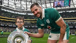 <p>MCCLOSKEY TO SUCCESS: Stuart McCloskey with his son Arlo and the Triple Crown trophy. Pic: Brendan Moran/Sportsfile</p>