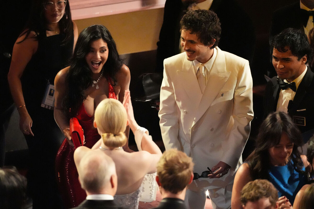 Kylie Jenner, left, and Timothee Chalamet, right, greet Elle Fanning in the audience before the Oscars on Sunday. Picture: AP Photo/Chris Pizzello.
