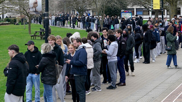 Students queue for antibiotics outside a building at the University of Kent in Canterbury (PA)