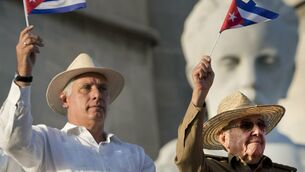<p>Cuba president Miguel Diaz-Canel, left, and his predecessor Raul Castro wave Cuban flags in Havana in 2021. File picture: Ramon Espinosa/AP</p>