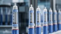 Close-up Medical Injector Pens on Conveyor Belt at Modern Pharmaceutical Factory. Insulin Pen on Production Line. Weight Loss Me