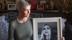<p>Julieanne Lynch with a picture of her daughter Kelly Marie, who was found dead on St Patrick's Day 2024. Ms Lynch said despite a peer review examining three reports into her death, the family remain 'completely in the dark' about any possible outcome. File picture </p>