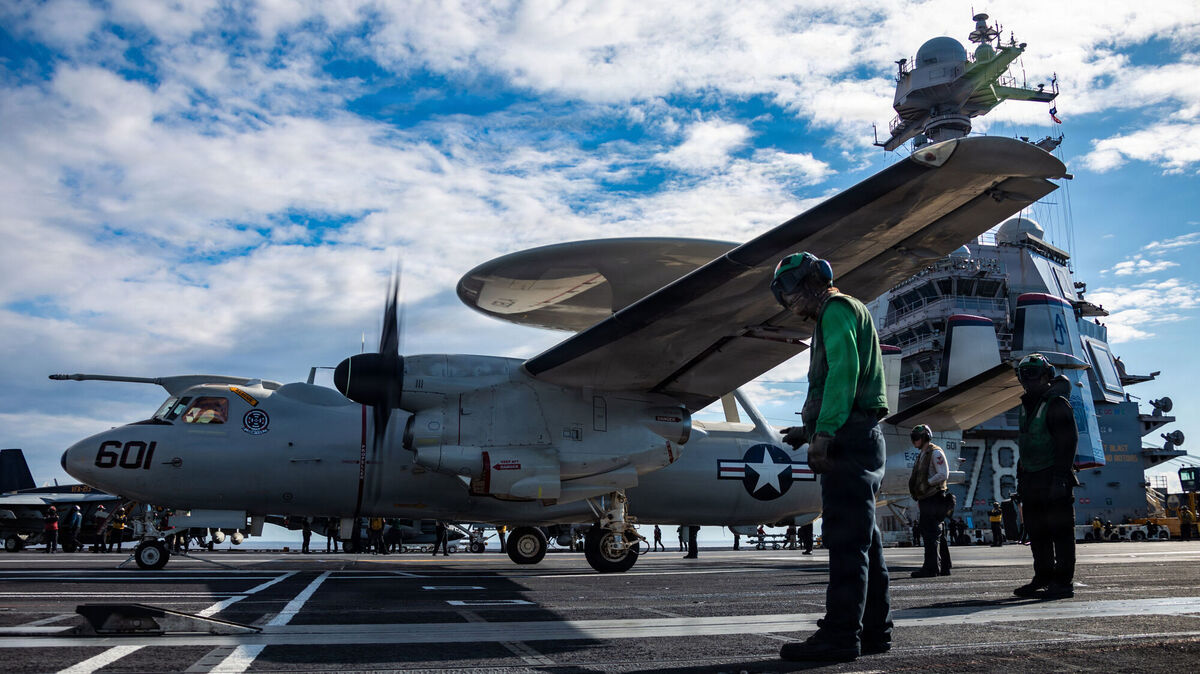 In this image provided by U.S. Central Command, U.S. Sailors observe as an E-2D Hawkeye aircraft, attached to Airborne Command and Control Squadron 124, approaches an aircraft catapult to launch from the flight deck of the world's largest aircraft carrier, USS Gerald R. Ford (CVN 78), while operating in support of Operation Epic Fury, on March 1, 2026. Picture; U.S. Navy via AP