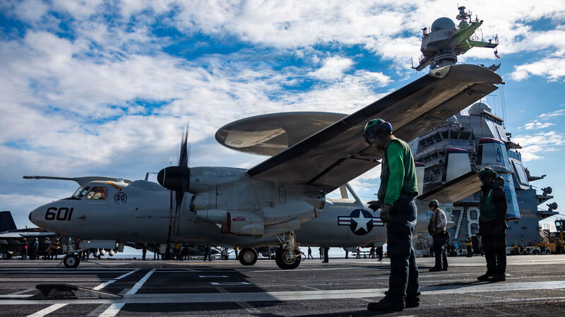 In this image provided by U.S. Central Command, U.S. Sailors observe as an E-2D Hawkeye aircraft, attached to Airborne Command and Control Squadron 124, approaches an aircraft catapult to launch from the flight deck of the world's largest aircraft carrier, USS Gerald R. Ford (CVN 78), while operating in support of Operation Epic Fury, on March 1, 2026. Picture; U.S. Navy via AP