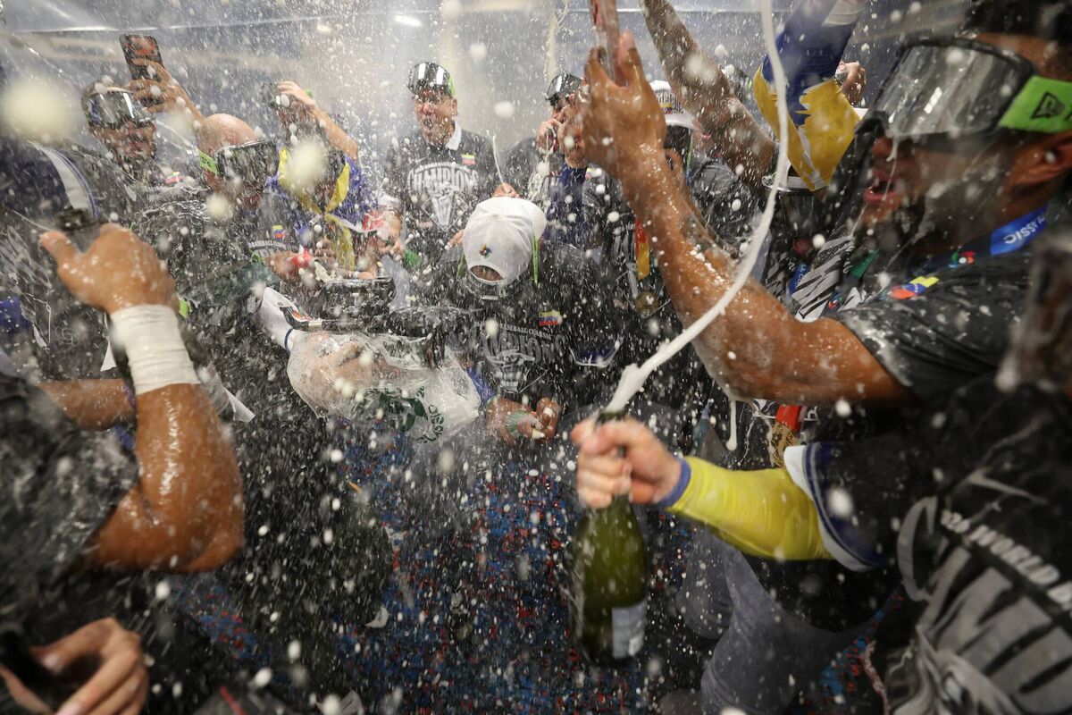 Members of Team Venezuela celebrate in the locker room (Photo by Al Bello/Getty Images)