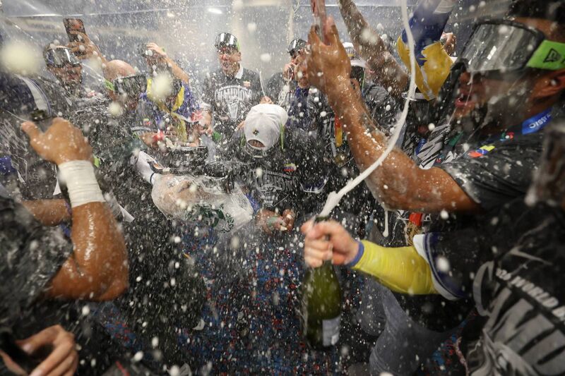 Members of Team Venezuela celebrate in the locker room (Photo by Al Bello/Getty Images)