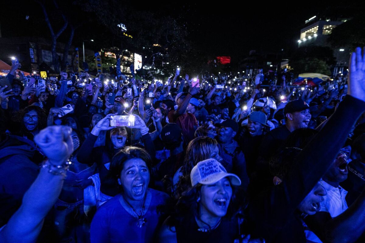 DAY OF JOY: Venezuela fans celebrate their national baseball team's victory in Caracas. Photo by Juan BARRETO / AFP via Getty Images