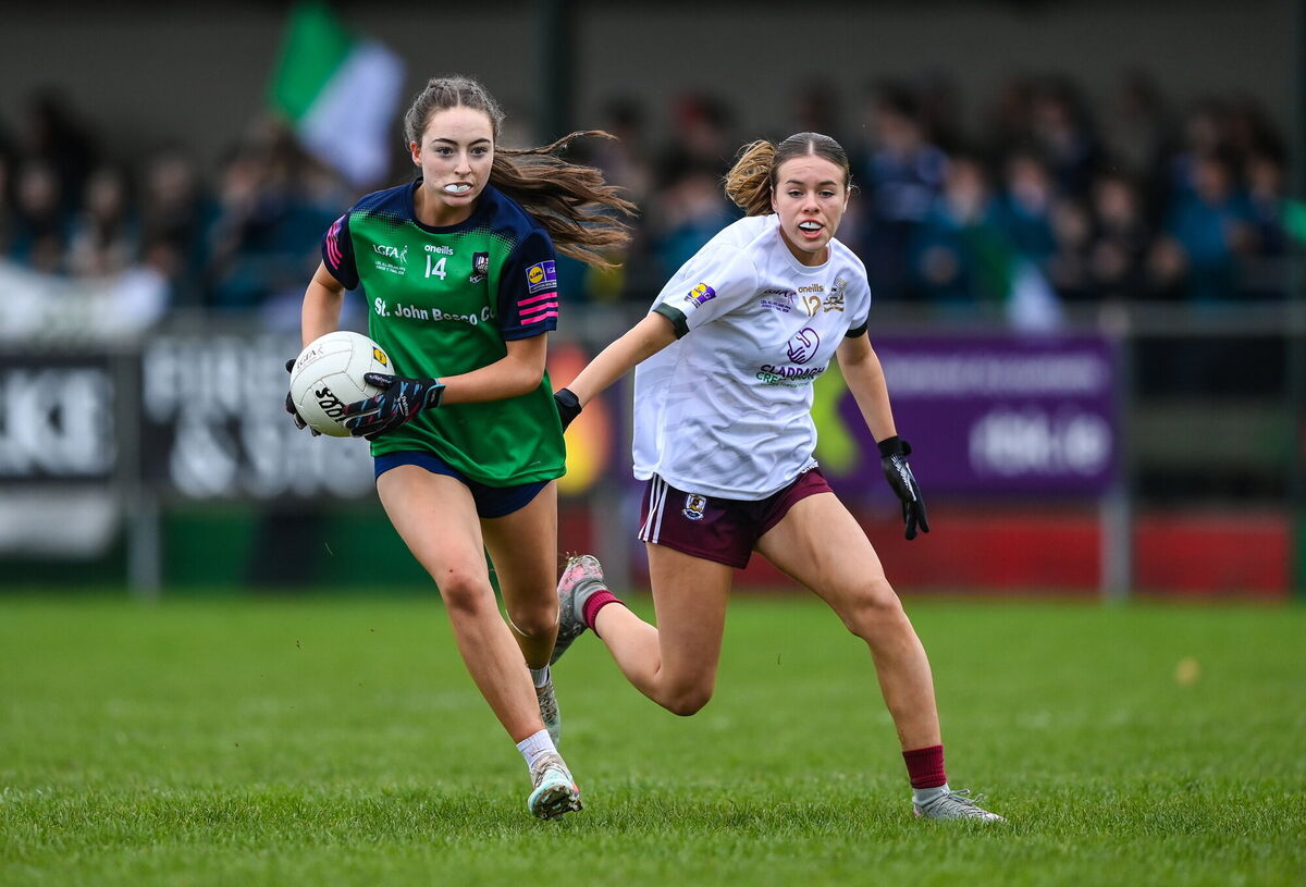 Caoimhe McMahon of St John Bosco Community College in action against Matilda Carroll of Salerno. Photo by Stephen McCarthy/Sportsfile