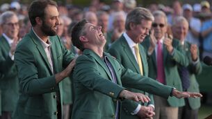 <p>DINNER'S READY: Scottie Scheffler puts the green Jacket on Rory McIlroy. Pic: AP Photo/Matt Slocum.</p>