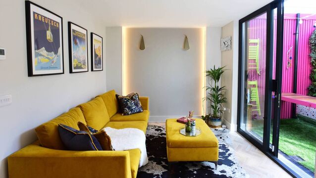<p>A turmeric couch and complementary colours for contrast in the living area at Jen Sheahan's home in Rathmines. Picture: Moya Nolan.</p>
