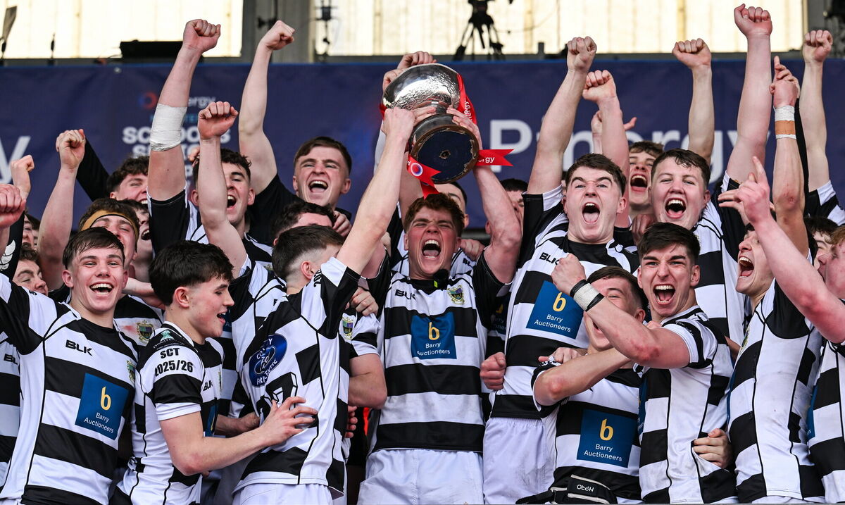 Rian MacFarlane O'Shea of Presentation Brothers College lifts the cup with his teammates. Pic: Paul Phelan/Sportsfile