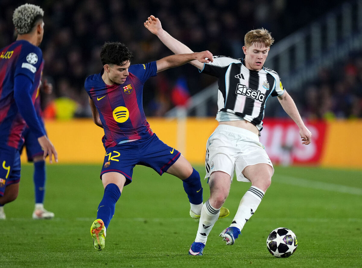 Newcastle United's Lewis Hall (right) is tackled by Barcelona's Xavi Espart. Pic: Mike Egerton/PA