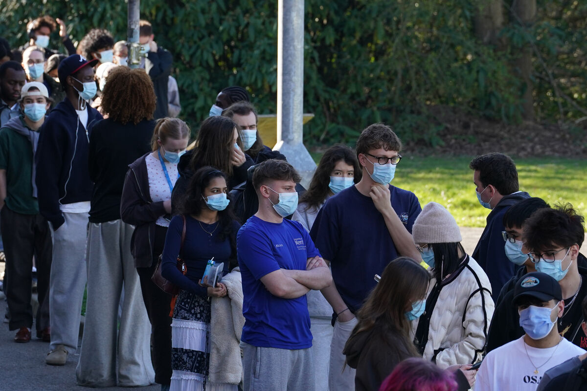 Students wait in line at the entrance to the sports hall at University of Kent campus in Canterbury, where the rollout of a meningitis B vaccine to about 5,000 students has begun.