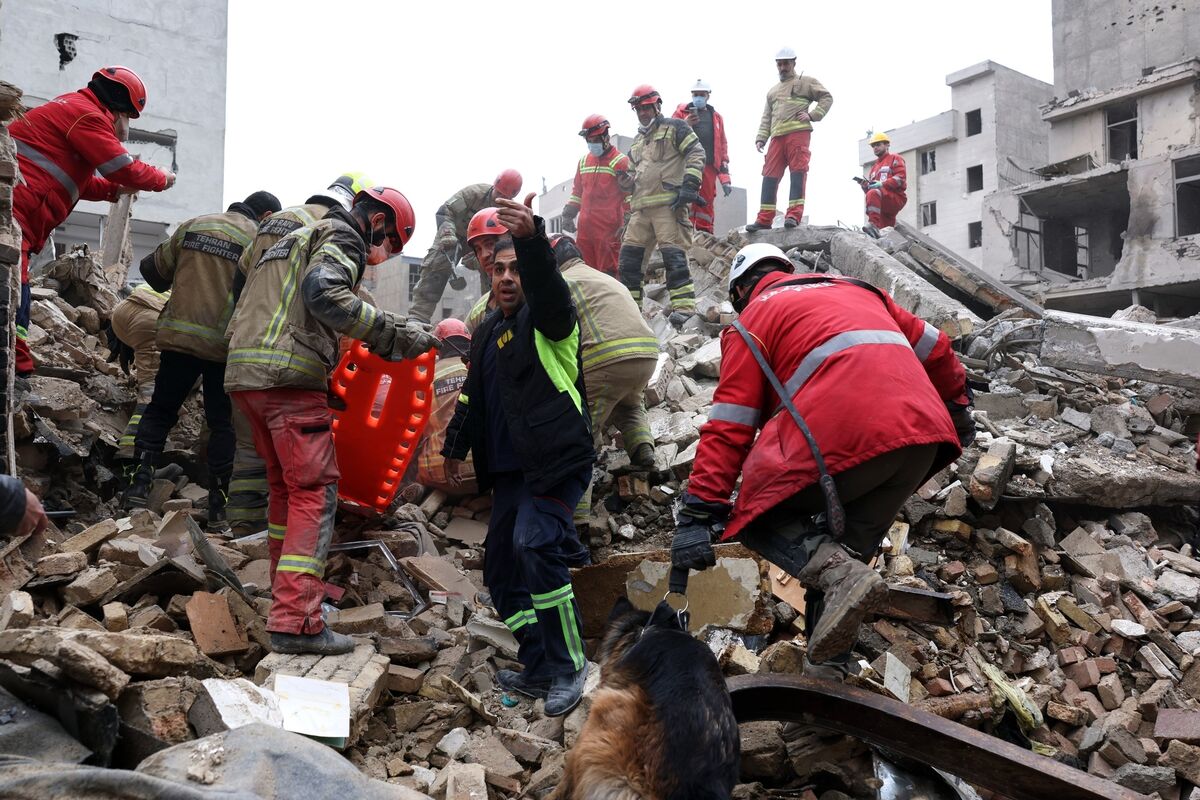Rescue workers search for survivors in the rubble after a strike in southern Tehran, Iran. Picture: Sajjad Safari/AP Rescue workers search for survivors in the rubble after a strike in southern Tehran, Iran. Picture: Sajjad Safari/AP