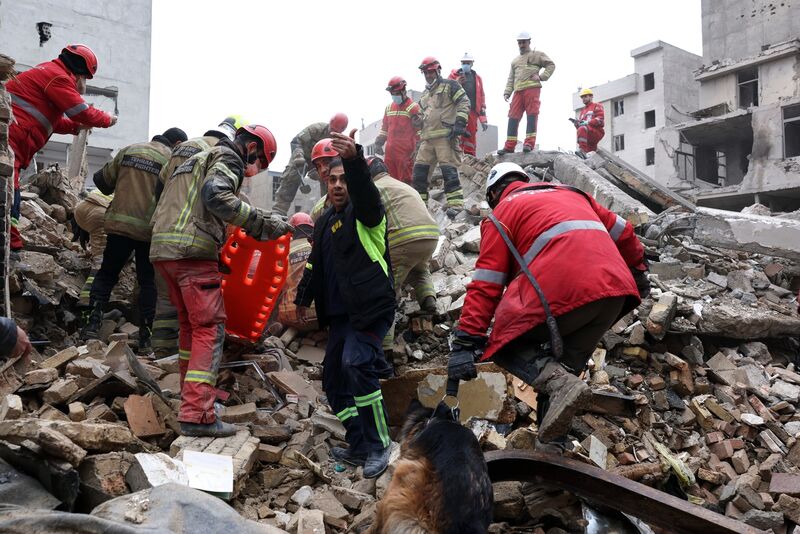 Rescue workers search for survivors in the rubble after a strike in southern Tehran, Iran. Picture: Sajjad Safari/AP