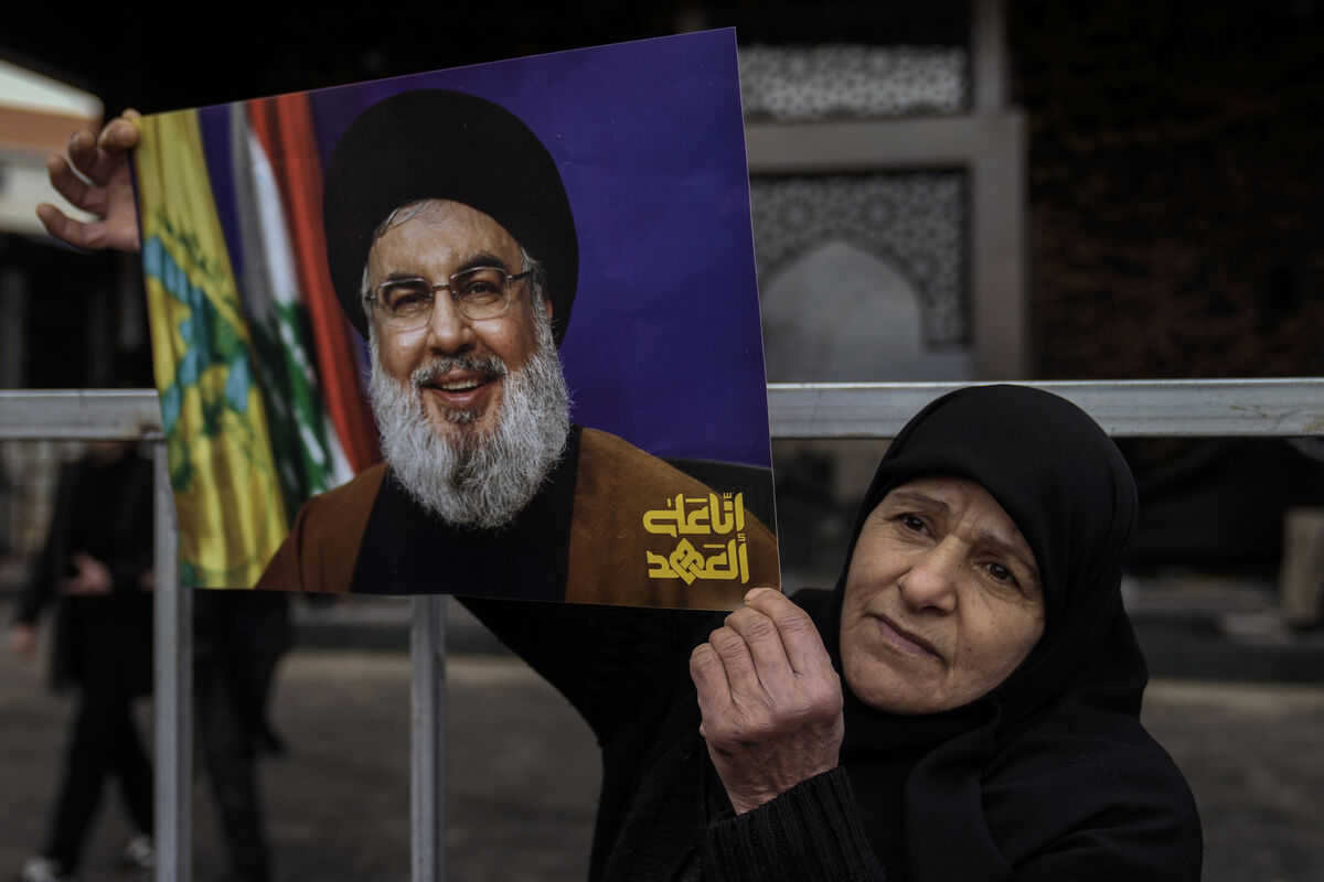 An Hezbollah supporter holds a picture of the late Lebanon's Hezbollah leader Sayyed Hassan Nasrallah, who was killed on September 27, 2024, by Israeli airstrikes, stands at the burial site in Beirut, Lebanon in 2025. Picture: AP Photo/Bilal Hussein An Hezbollah supporter holds a picture of the late Lebanon's Hezbollah leader Sayyed Hassan Nasrallah, who was killed on September 27, 2024, by Israeli airstrikes, stands at the burial site in Beirut, Lebanon in 2025. Picture: AP Photo/Bilal Hussein