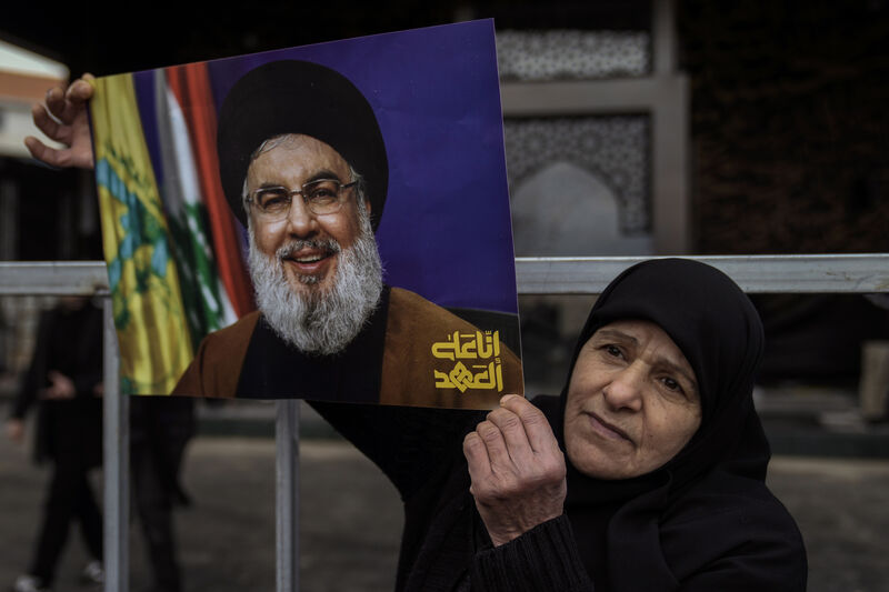An Hezbollah supporter holds a picture of the late Lebanon's Hezbollah leader Sayyed Hassan Nasrallah, who was killed on September 27, 2024, by Israeli airstrikes, stands at the burial site in Beirut, Lebanon in 2025.  Picture: AP Photo/Bilal Hussein