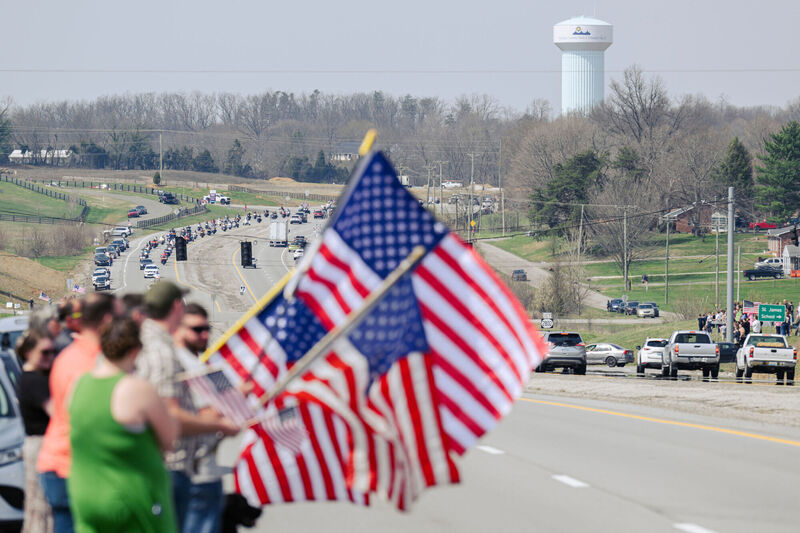 Spectators and supporters await the hearse and procession of Army Sgt. Benjamin N. Pennington, 26, of Glendale, Ky, March 20, 2026, in Elizabethtown, Ky. (AP Photo/Jon Cherry)