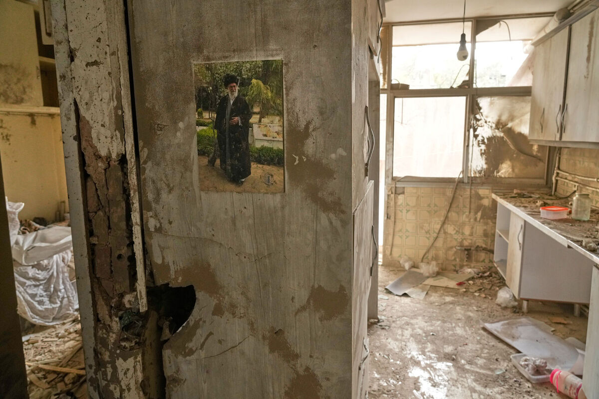 A poster of the late Iranian Supreme Leader Ayatollah Ali Khamenei is pasted on the wall of a residential building damaged after a nearby police station was struck two days earlier in a US-Israeli attack in Tehran. Picture: AP Photo/Vahid Salemi