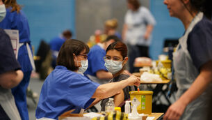 <p>A student receiving an injection in the sports hall at the University of Kent campus in Canterbury (Gareth Fuller/PA)</p>